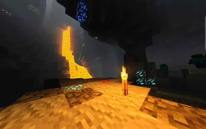 Glowing torch in a vibrant cave with lava
