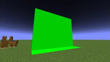 Bright green screen wall on grassy terrain