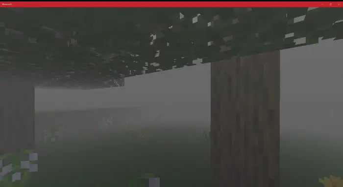 Dense fog surrounds blocky trees and grass.