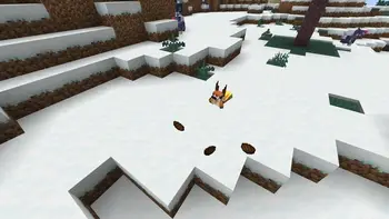 Fox walking in a snowy, hilly landscape