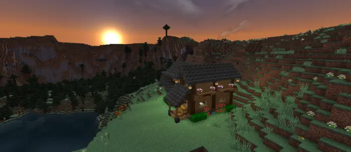 Mountain house by lake at sunset