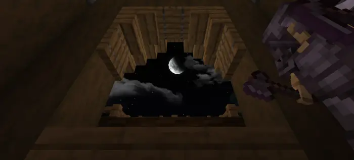 Crescent moon seen from spruce house window