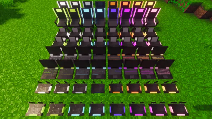 Row of colorful decorative laptops on grass