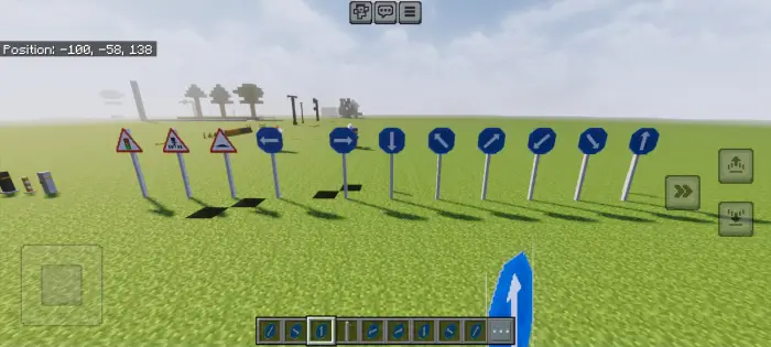Various road signs placed on grassy terrain