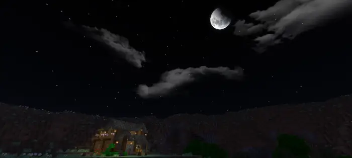 Mountain house near lake under night sky