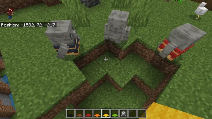 Three golems in colored capes on grassy terrain