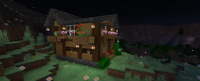 Two-story wooden mountain house at night