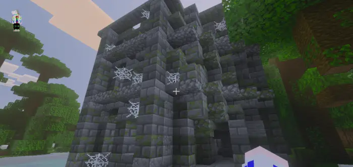 Ancient stone tower with cobwebs and vines