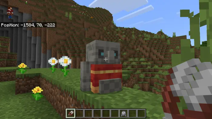 Stone golem with red scarf on grassy hill