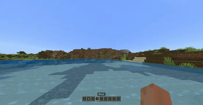 First-person view over water and grassy hills
