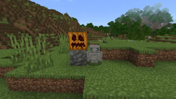 Small golem and pumpkin statue on grassy hill
