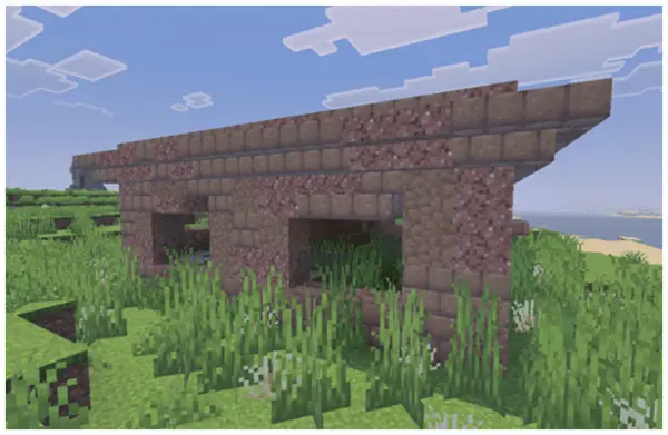 Overgrown stone ruins in grassy landscape