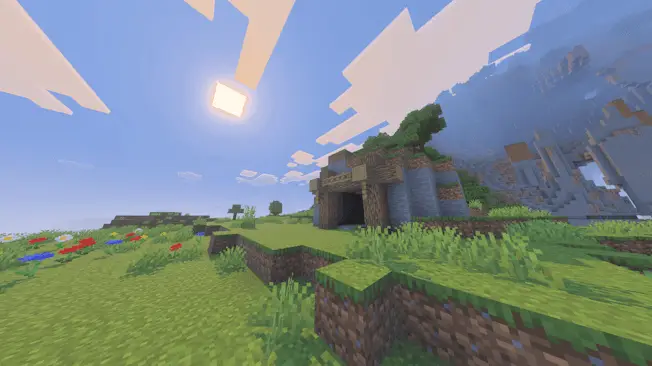 Cave entrance on a grassy hillside at sunrise