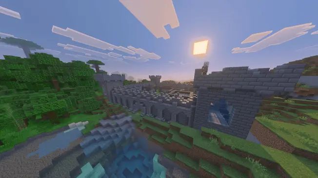 Stone castle overlooking river at sunset