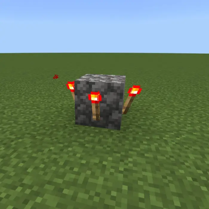 Cobblestone block with four red torches
