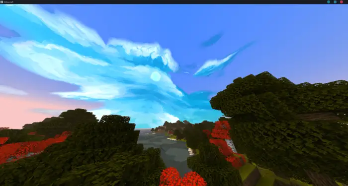 Bright blue sky with stylized clouds above trees