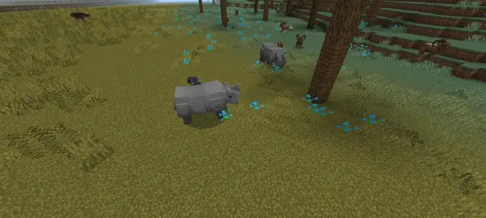 Blocky rhinos and animals roam grassy field