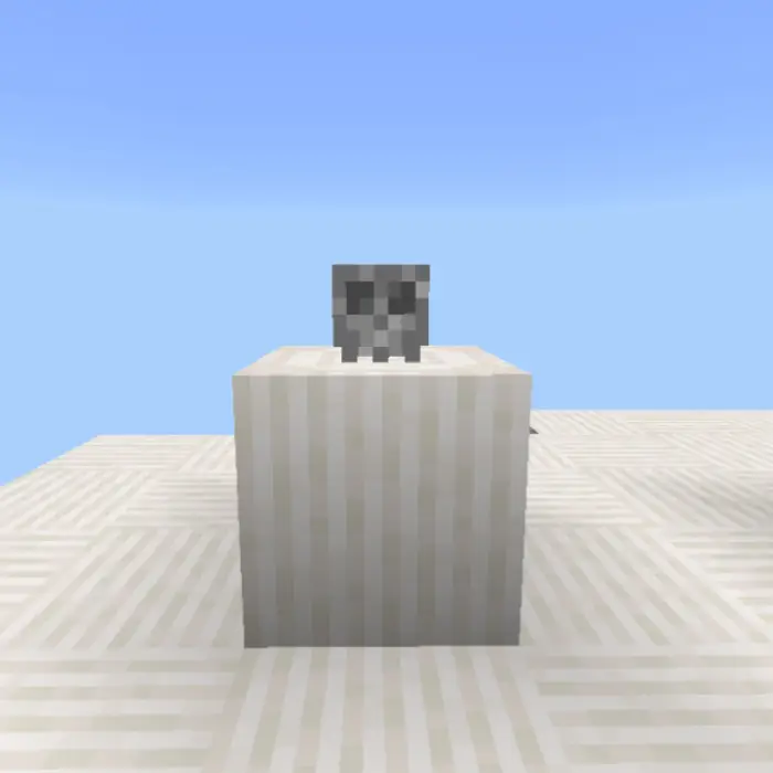 Pixelated skull atop a white block.