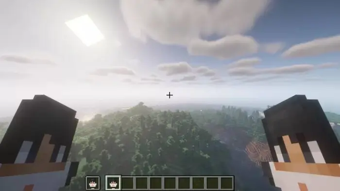 Player holds two custom totems over landscape