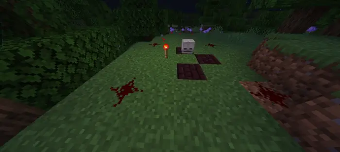 ALT text Bloody cross, skull, and torch on grass.