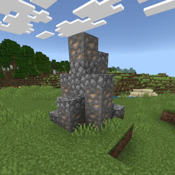 Stone and ore pillar structure in grassy field