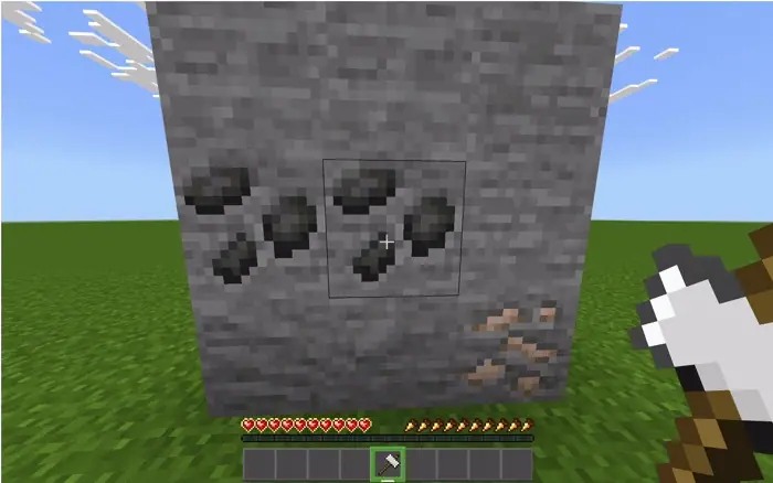 Player mining coal and iron with a hammer