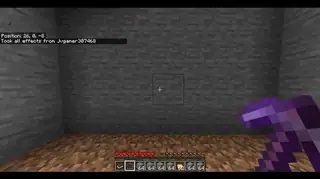 Player holding pickaxe in front of stone wall