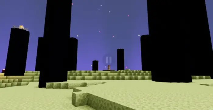 Tall black pillars under a vibrant sky