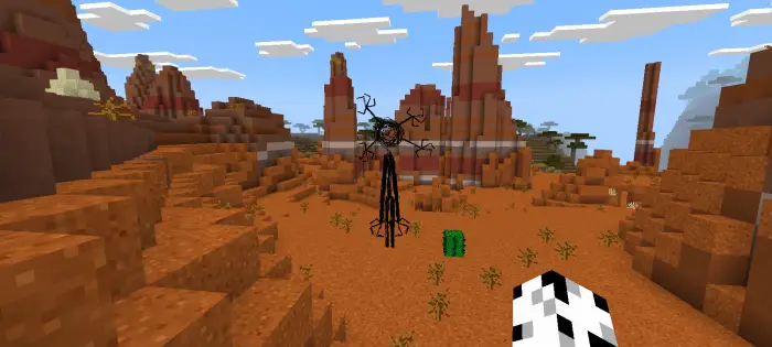 Tall eerie creature stands in a red mesa biome.