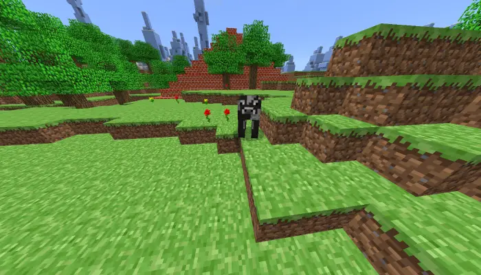 Blocky cow on grassy terrain with trees