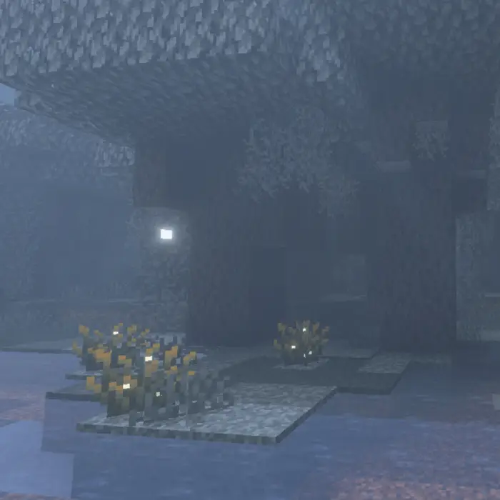 Misty stone cave with glowing plants.