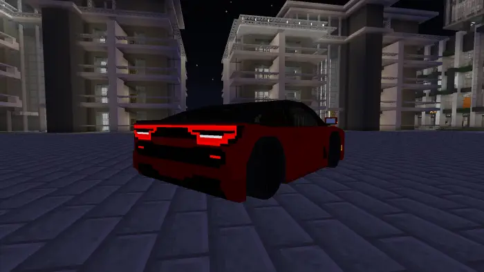Blocky red truck parked in city at night