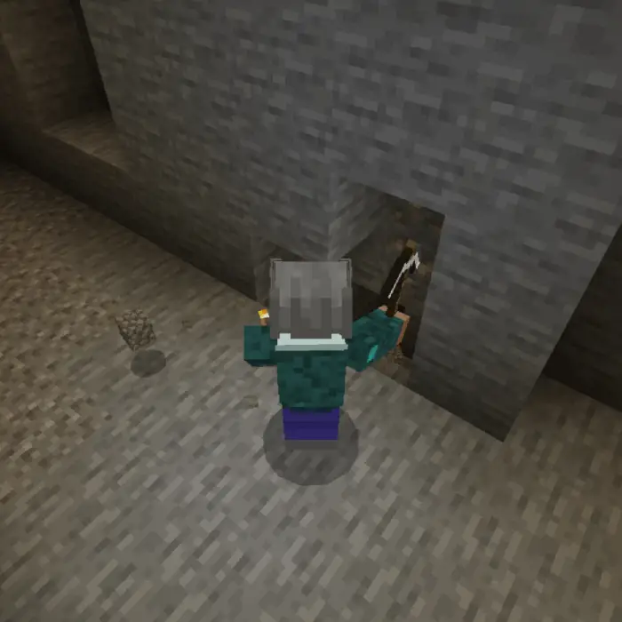 Player mining with a glowing torch underground