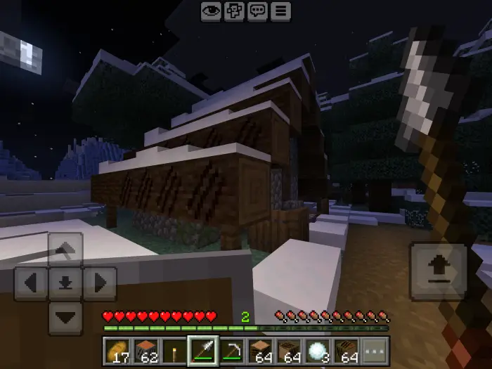 Snowy cabin at night with torch in hand