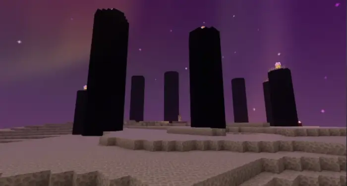 Tall obsidian pillars under a purple sky