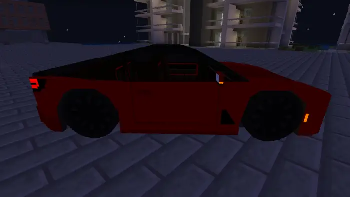 Blocky red car parked on city street at night