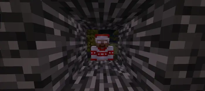 Character in red peers through stone tunnel