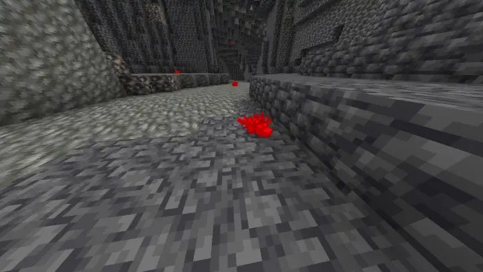 Red ore clusters on stone cave floor