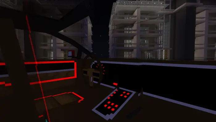 Truck dashboard view with city buildings at night