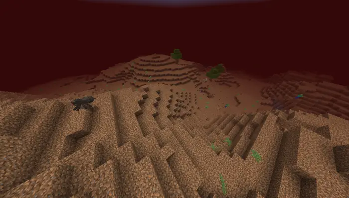 Blocky terrain with sparse trees and creature