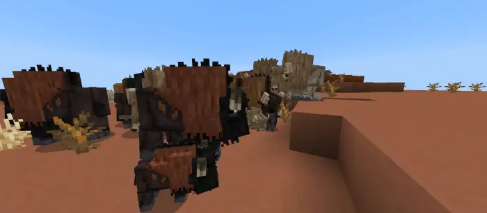 Blocky bison herd roams a dusty landscape