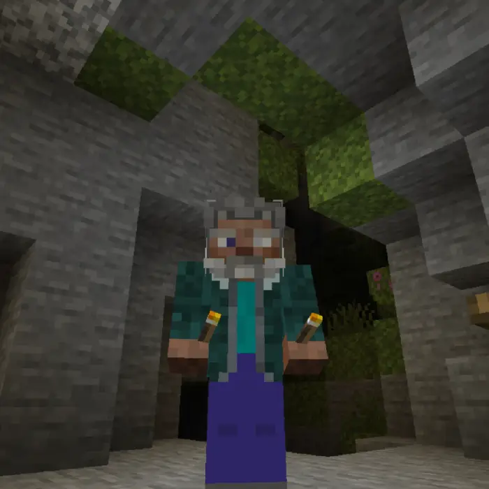 Character holding torches in a cave