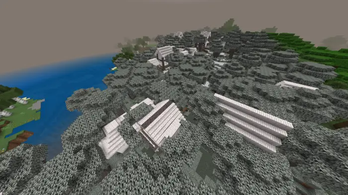 Snow-covered village buildings in a forest