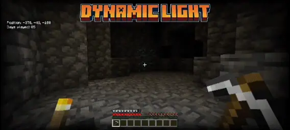 Player holds pickaxe in a dark cave.