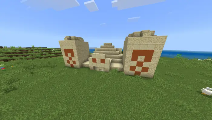 Desert temple on a grassy plain by water