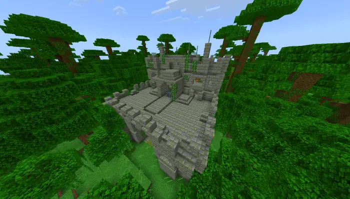 Stone castle ruins surrounded by jungle trees