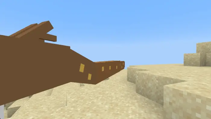 Blocky brown serpent slithers on sand