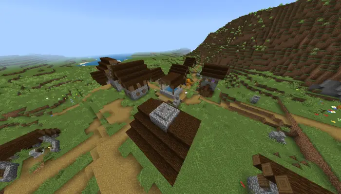 Village surrounded by grassy plains and hills