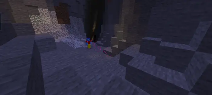 Player explores dark cave with eerie lights.