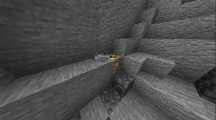 Silverfish crawling near gold ore in a cave